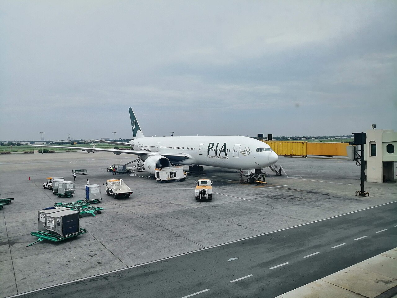 A Pakistan International Airlines Boeing 777-200ER parked at an airport terminal.