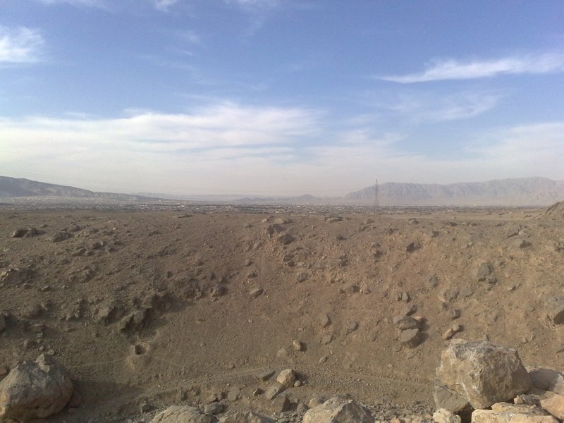 A wide view over Quetta city in Balochistan, with low buildings and hills visible under a clear sky.