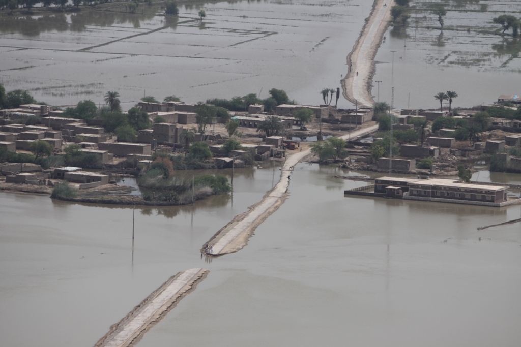 Aerial view of floodwaters covering fields and a settlement in Pakistan.
