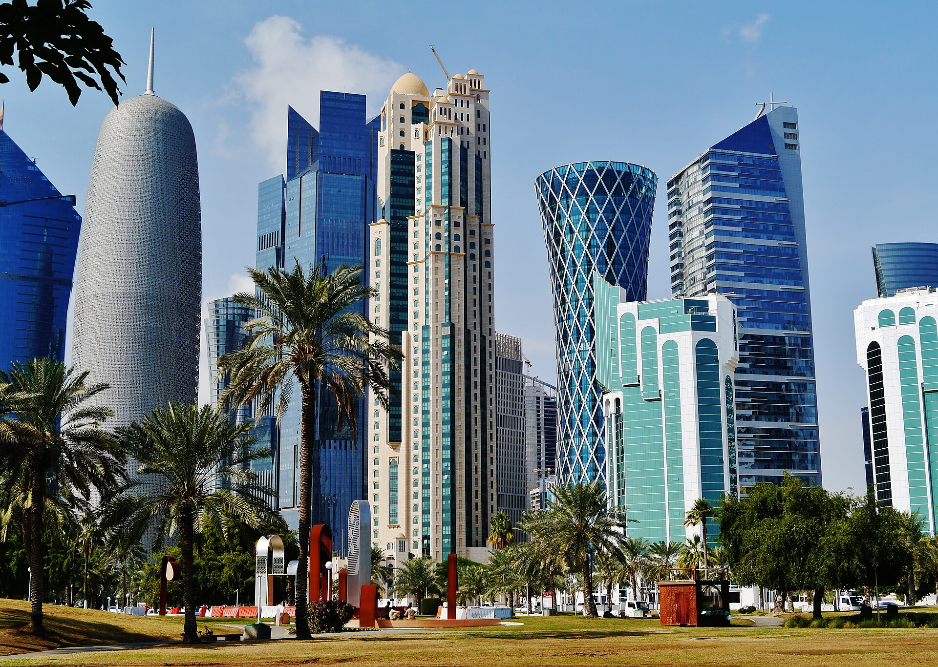 The Doha skyline at dusk, with high-rise towers along the waterfront.