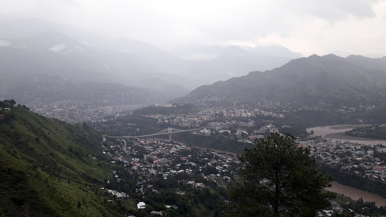 A view of Muzaffarabad, the capital of Azad Jammu and Kashmir, with the Neelum river and surrounding hills.