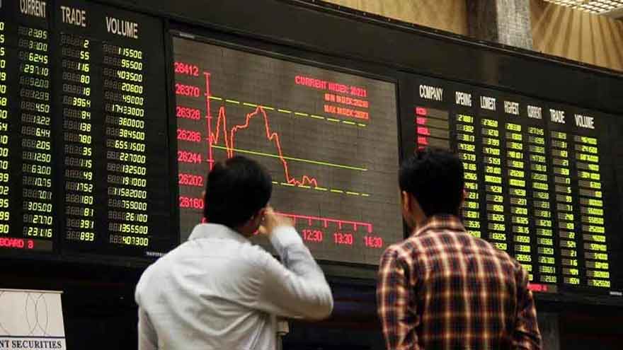 Two men in shirts watch a large electronic board showing a falling benchmark index chart and stock listings