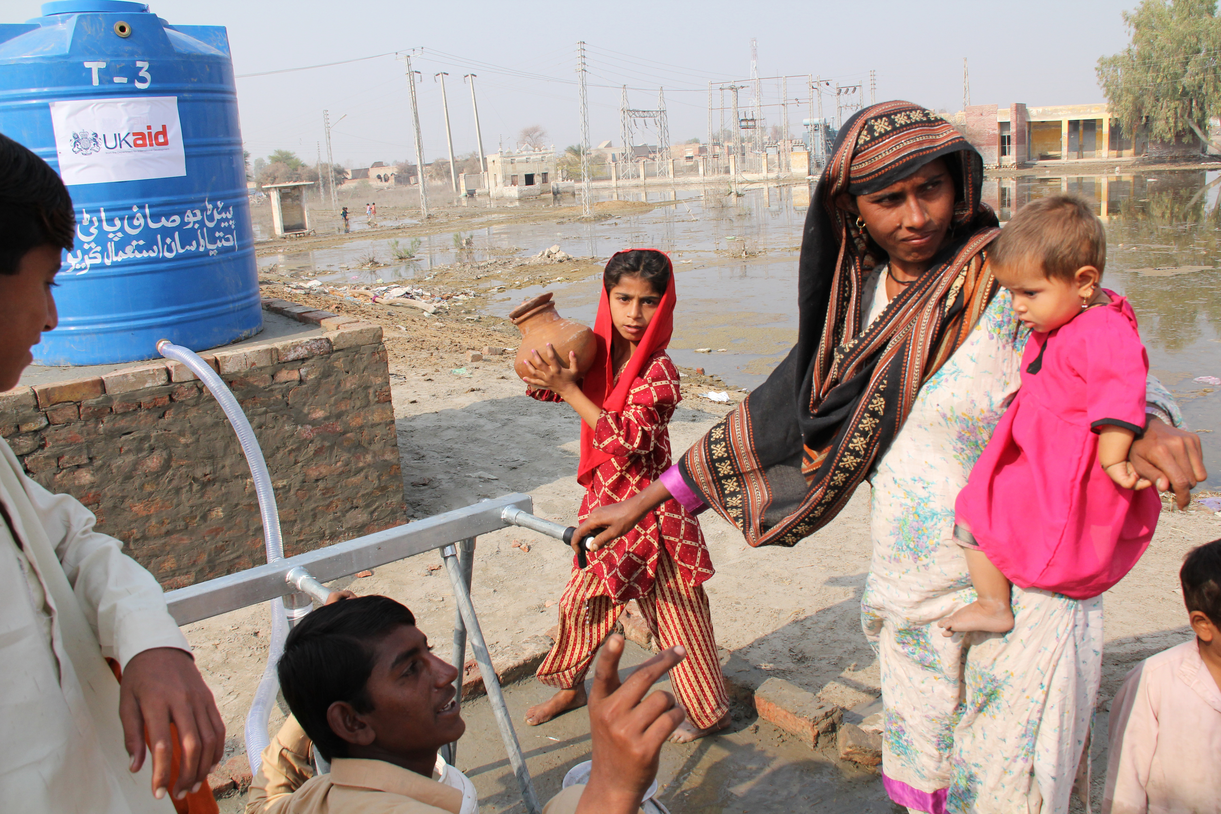 People collecting clean drinking water from a tapstand in a village in Sindh, Pakistan.