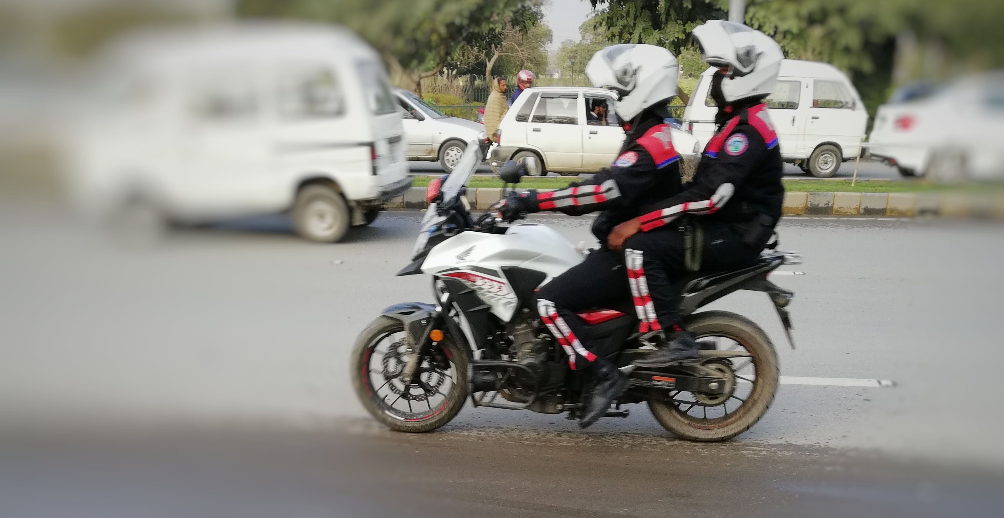 Punjab Police Dolphin Force patrollers in protective vests on a road in Lahore
