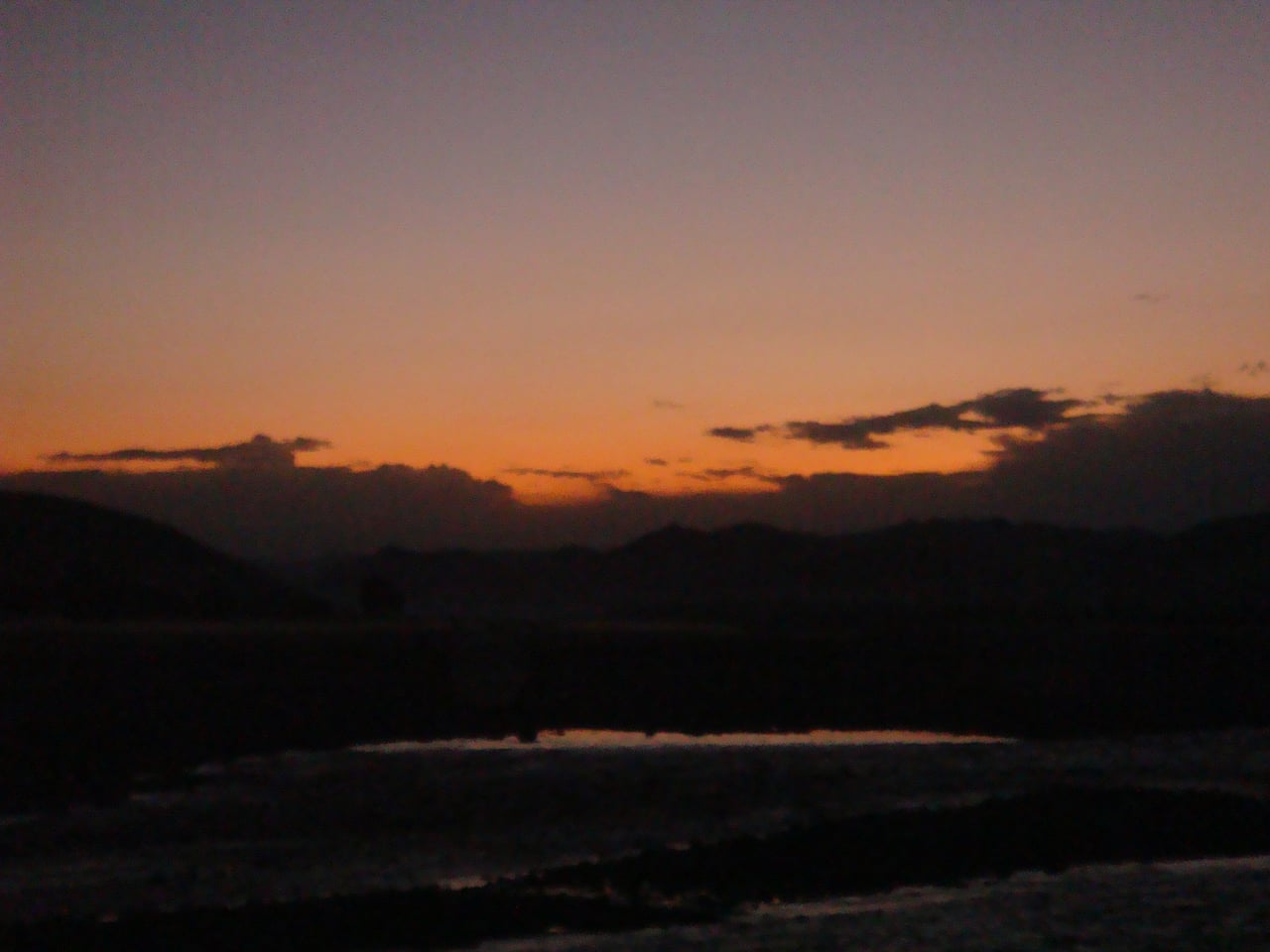 Sunset over the Tochi River in North Waziristan, with hills in the distance.