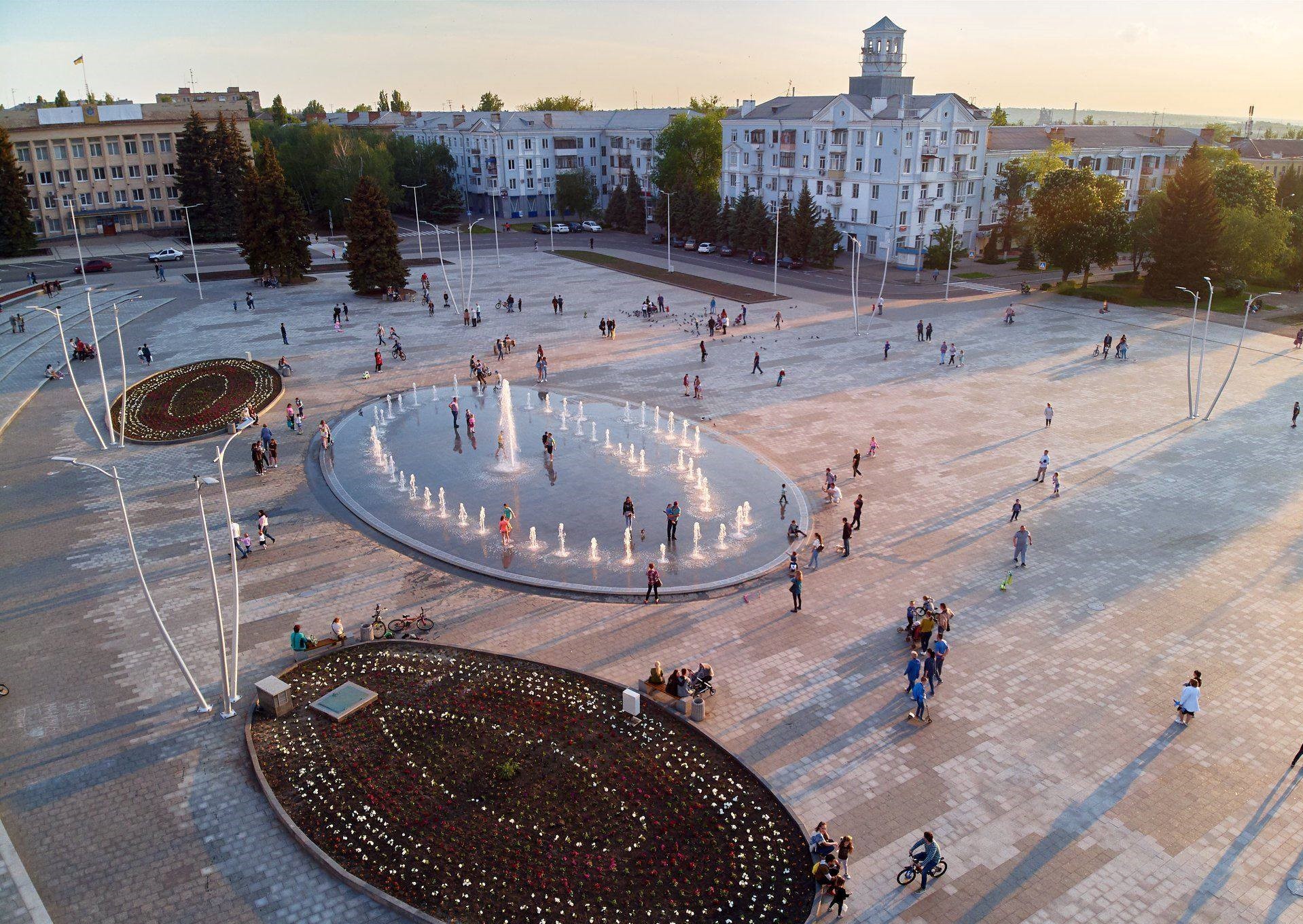 An elevated view over Myru Square in Kramatorsk, showing the city council building, apartment blocks and a wide plaza.