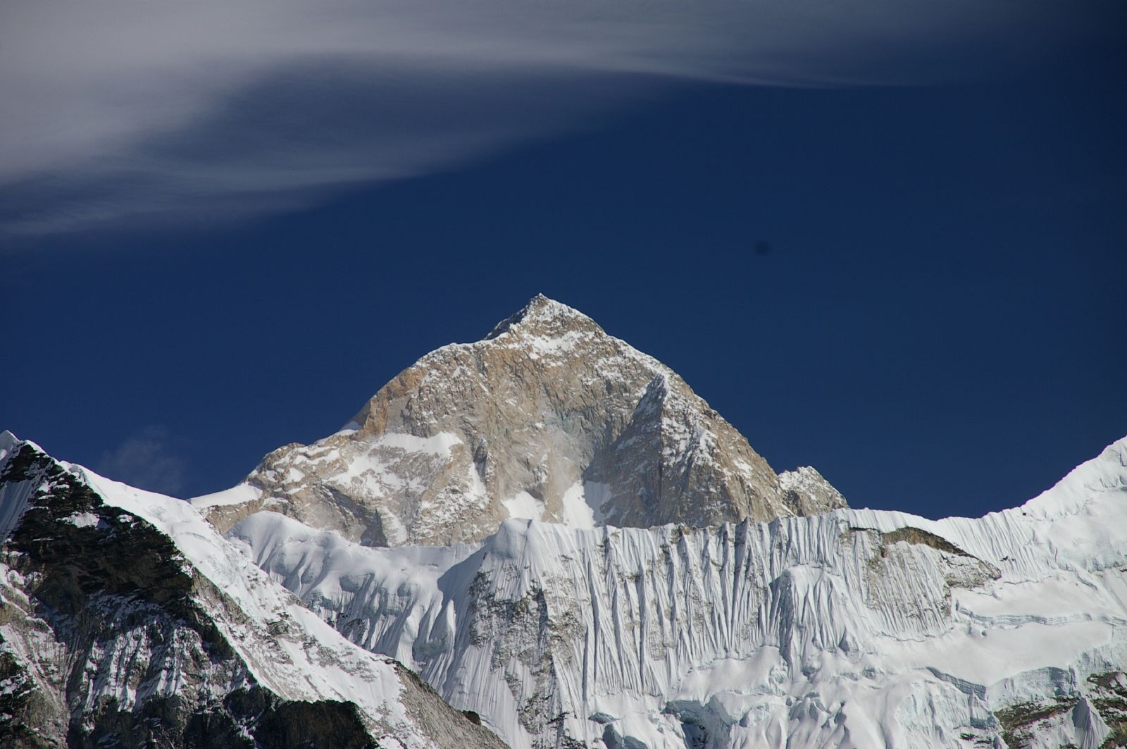 Mount Makalu, a steep snow-covered Himalayan peak, rising above surrounding ridges