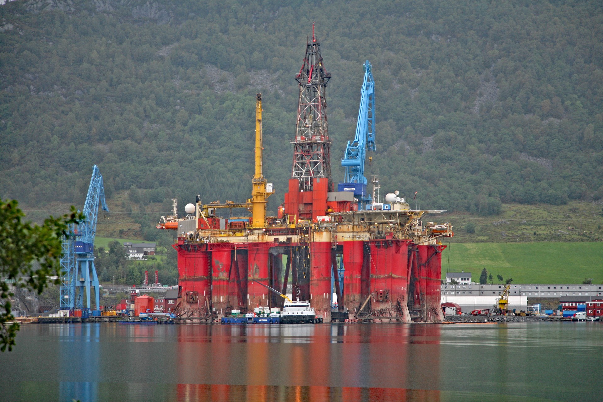 An offshore oil and gas drilling platform standing in the water.