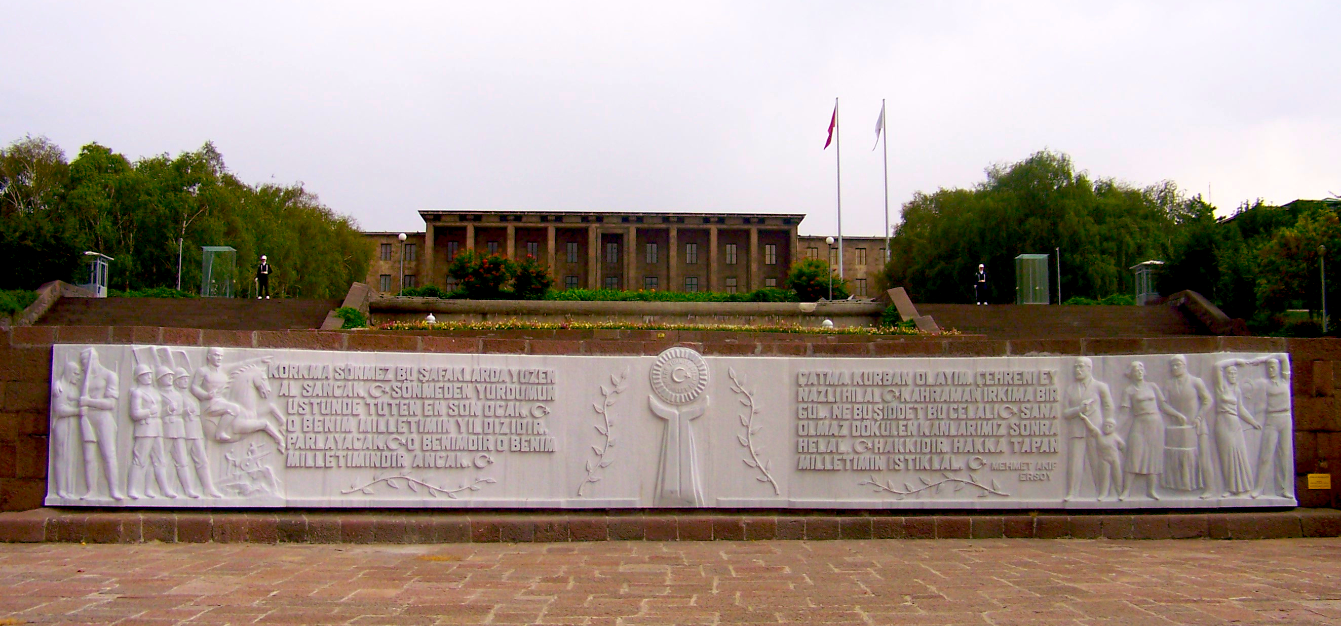 Exterior view of the Grand National Assembly of Turkey in Ankara, showing its long colonnaded facade and broad forecourt.