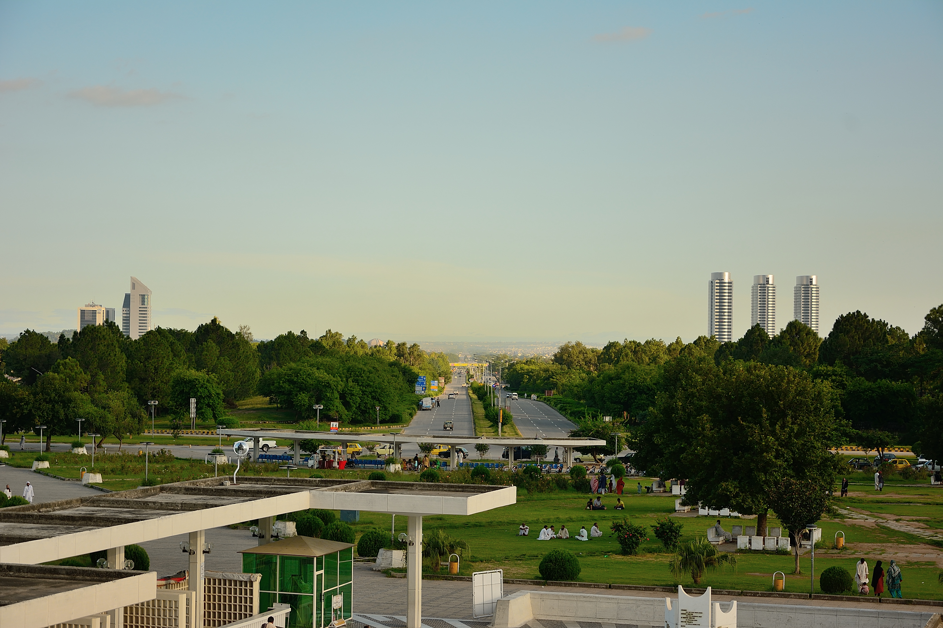 A view of Jinnah Avenue in Islamabad looking north from the Faisal Mosque, with the city's commercial buildings stretching along the road