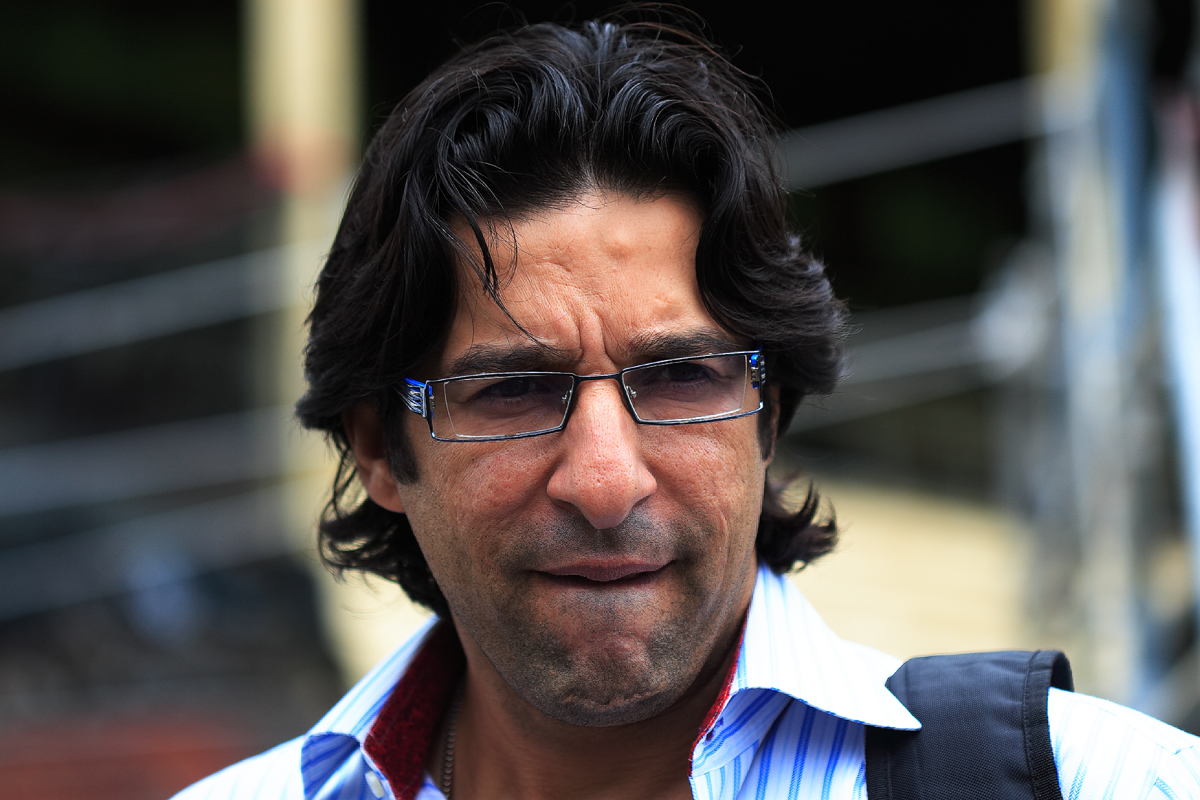 Former Pakistan captain Wasim Akram speaking at an event in a dark blazer