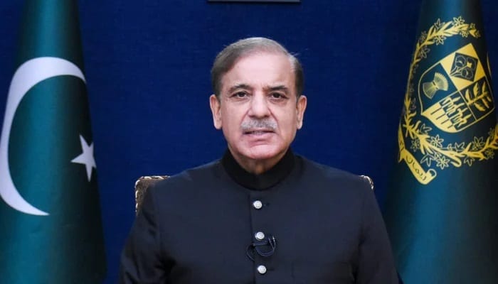 Prime Minister Shehbaz Sharif speaking at a podium during a public address.